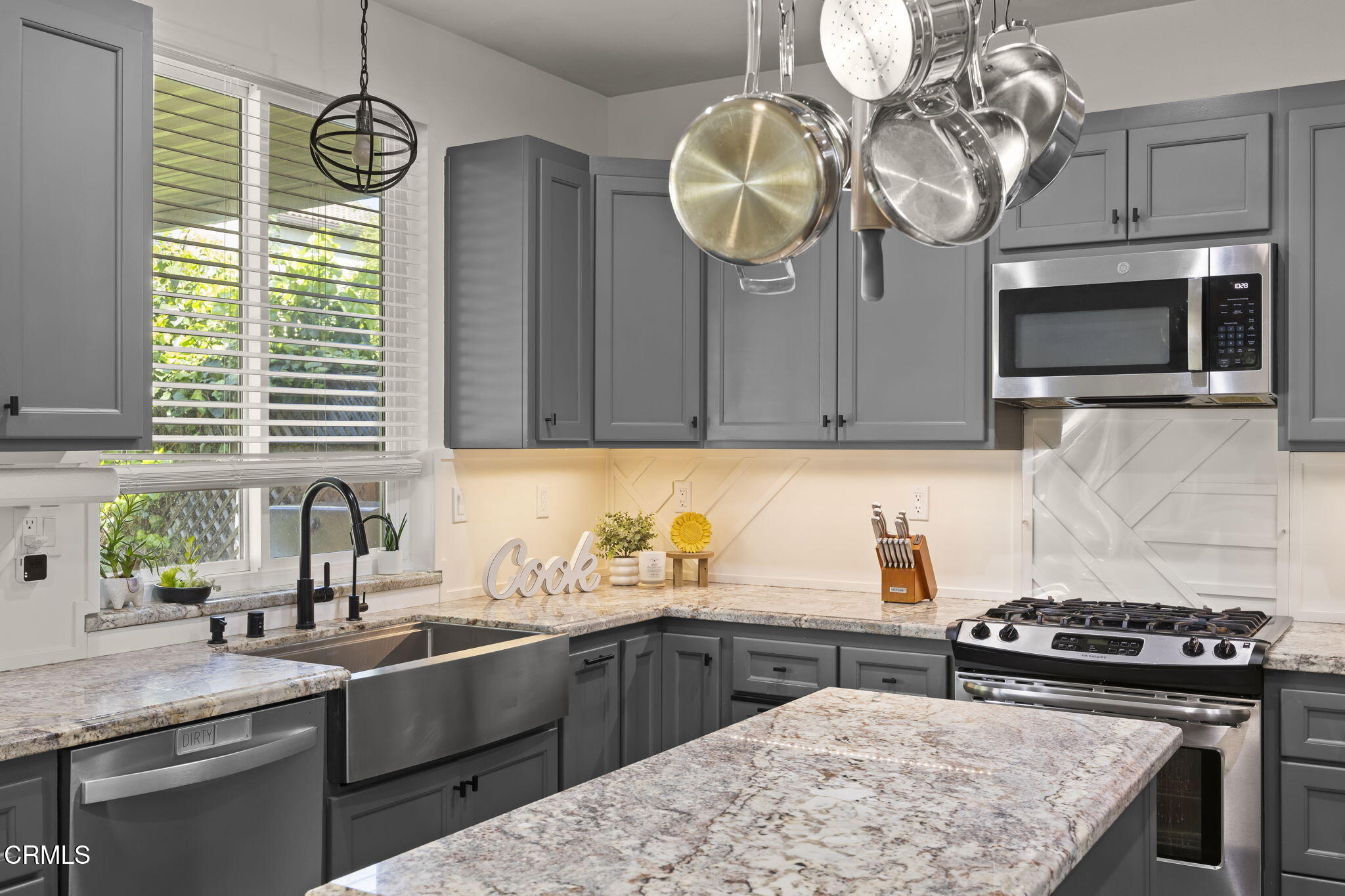803 Noontide Way Oxnard, CA 93035 - Photo 12 of 44 a kitchen with stainless steel appliances granite countertop a sink a stove a microwave cabinets and wooden floor