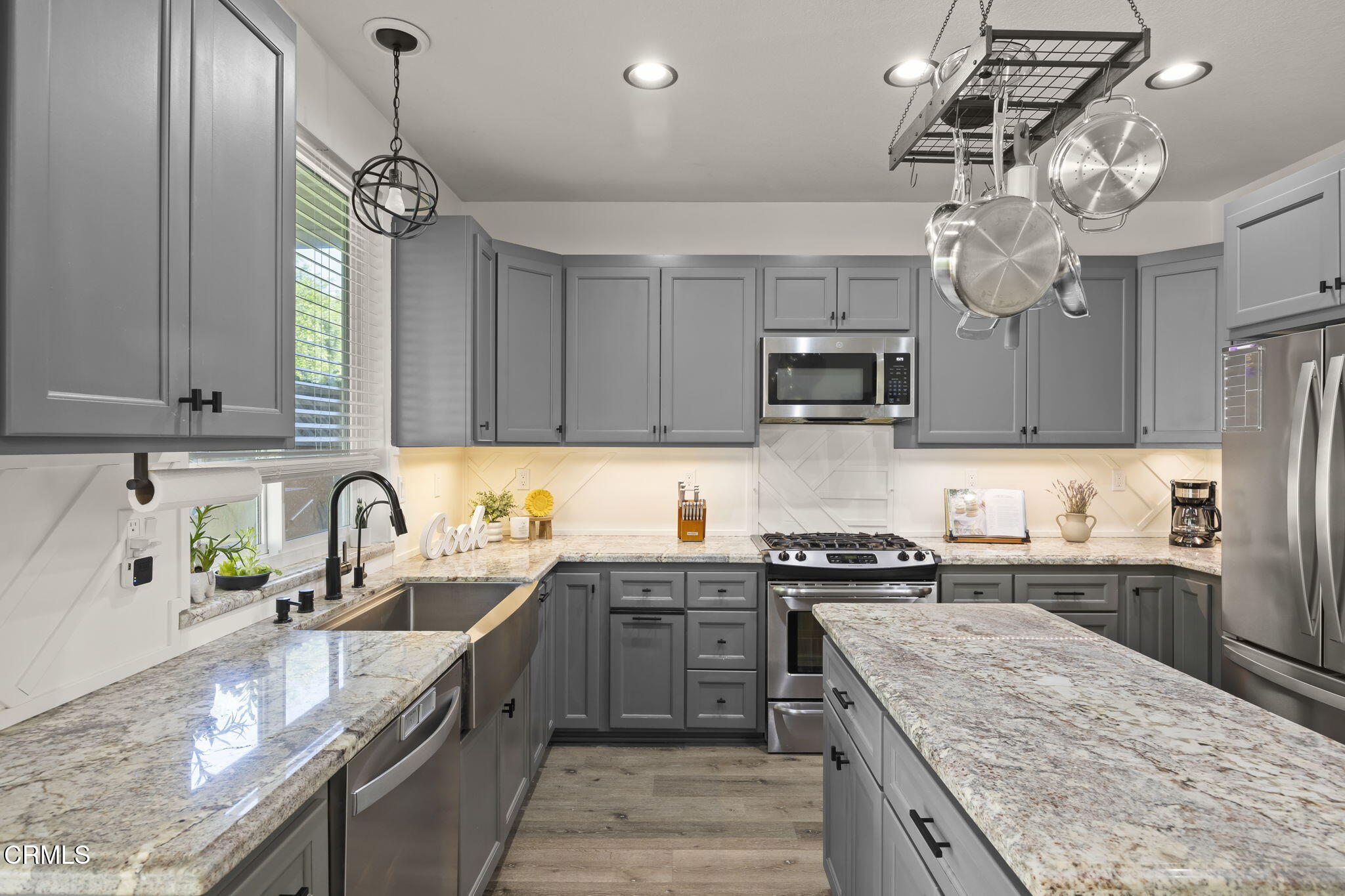 803 Noontide Way Oxnard, CA 93035 - Photo 13 of 44 a kitchen with stainless steel appliances granite countertop a sink a stove top oven a counter space and cabinets