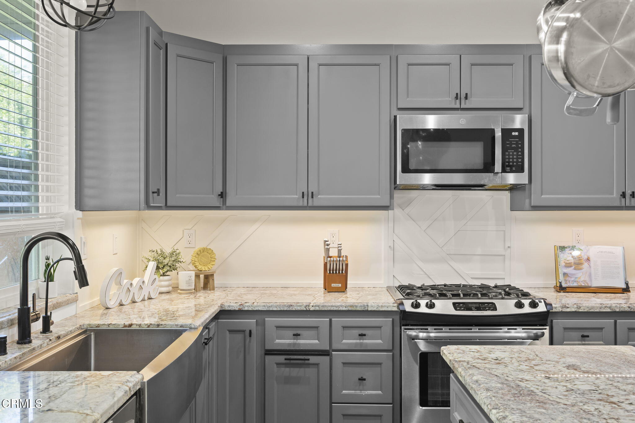 803 Noontide Way Oxnard, CA 93035 - Photo 14 of 44 a kitchen with granite countertop a stove top oven sink and cabinets