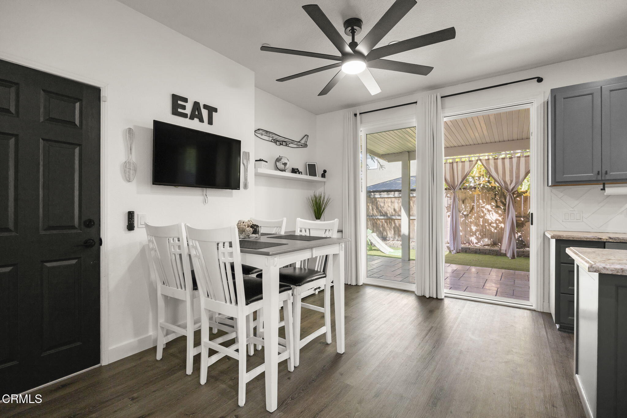 803 Noontide Way Oxnard, CA 93035 - Photo 17 of 44 a view of a livingroom with furniture a flat screen tv and wooden floor