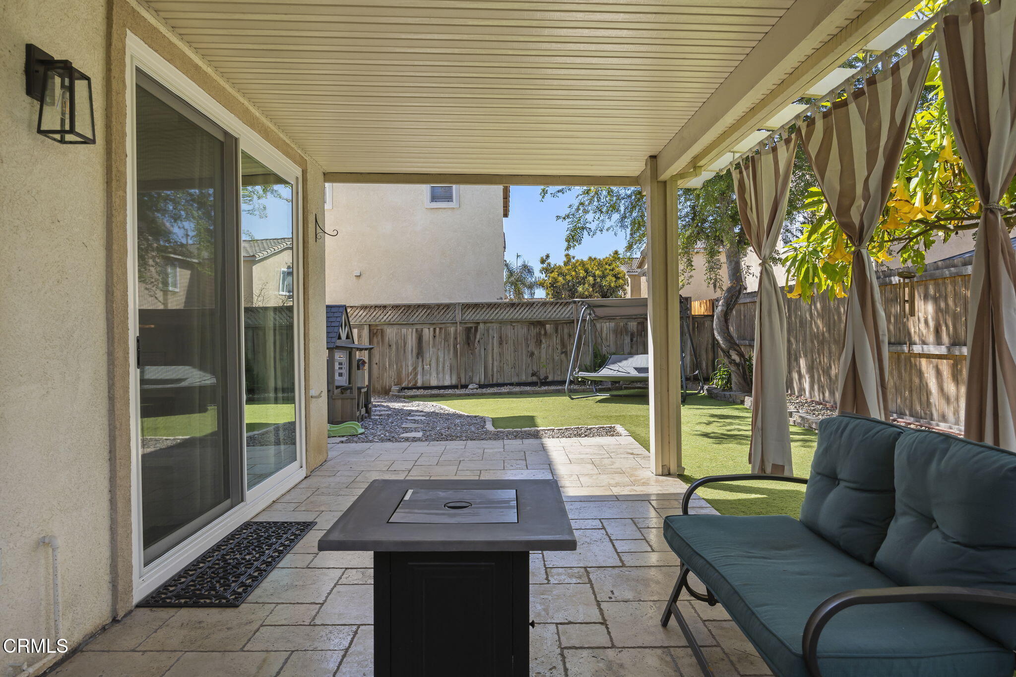 803 Noontide Way Oxnard, CA 93035 - Photo 19 of 44 a view of a patio with table and chairs with wooden floor and fence