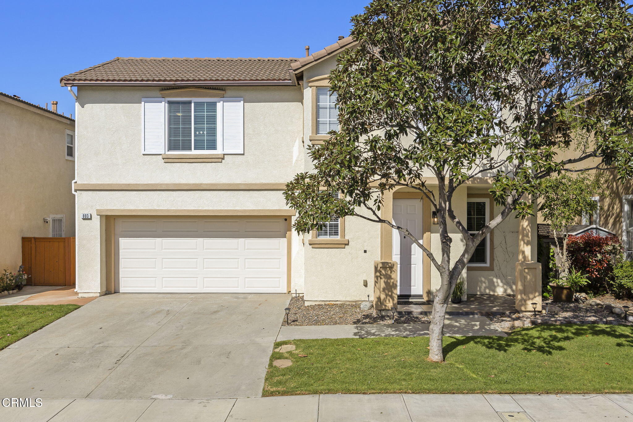 803 Noontide Way Oxnard, CA 93035 - Photo 2 of 44 a front view of a house with a yard and garage