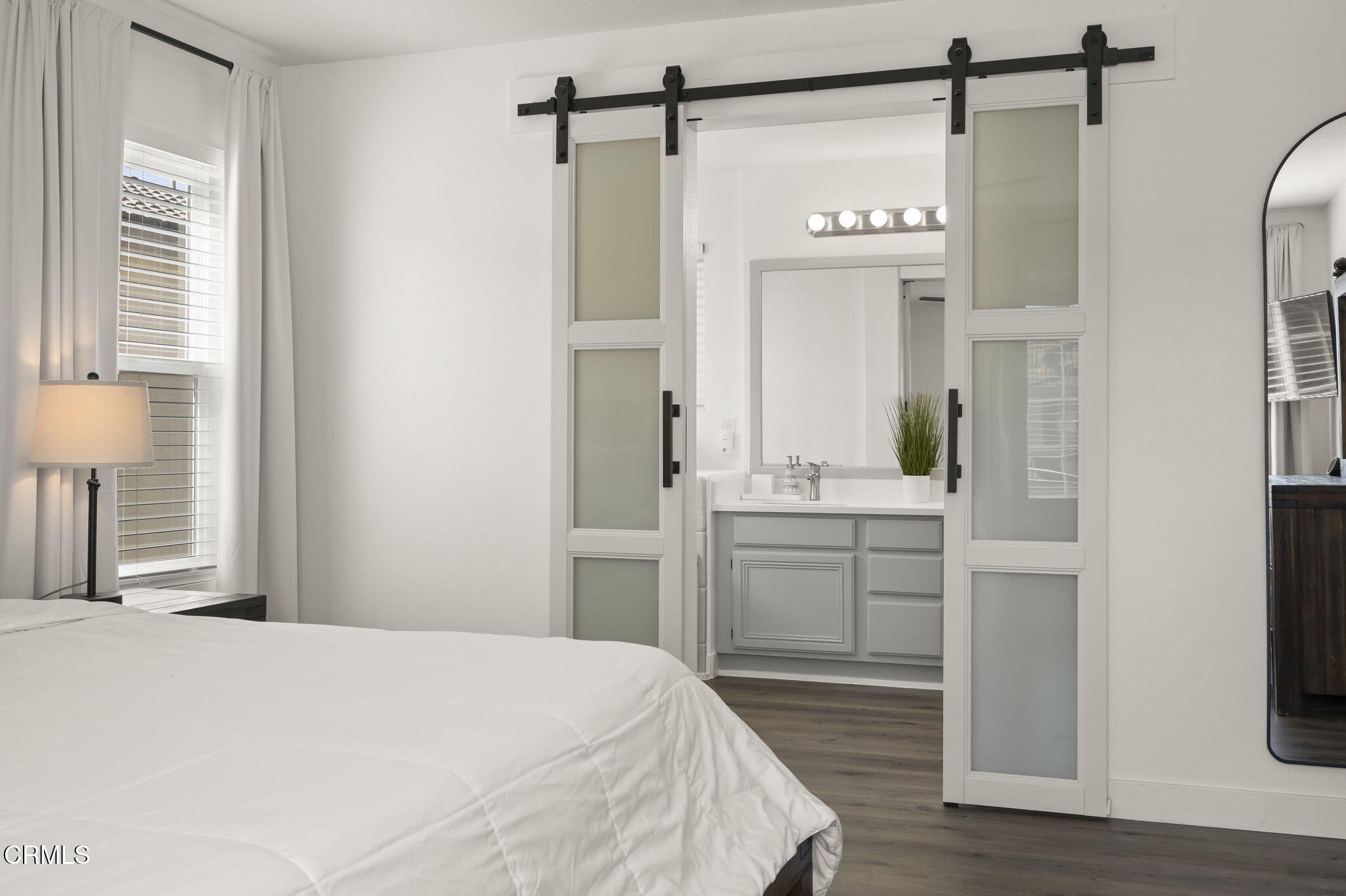 803 Noontide Way Oxnard, CA 93035 - Photo 24 of 44 a bedroom with a bed and a mirror