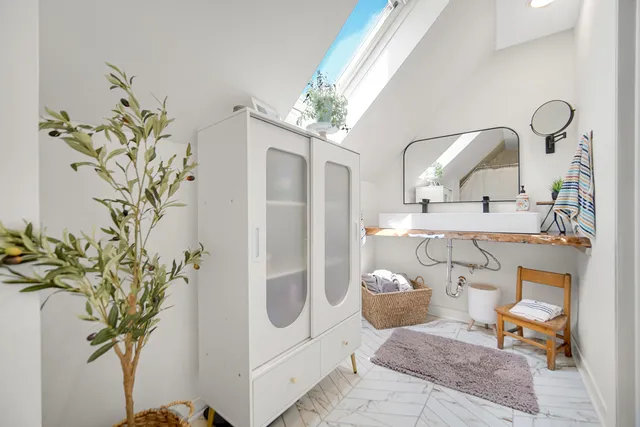 a view of a bathroom with a sink and mirror
