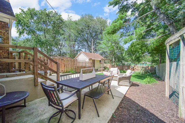 a view of a chairs and table in the patio