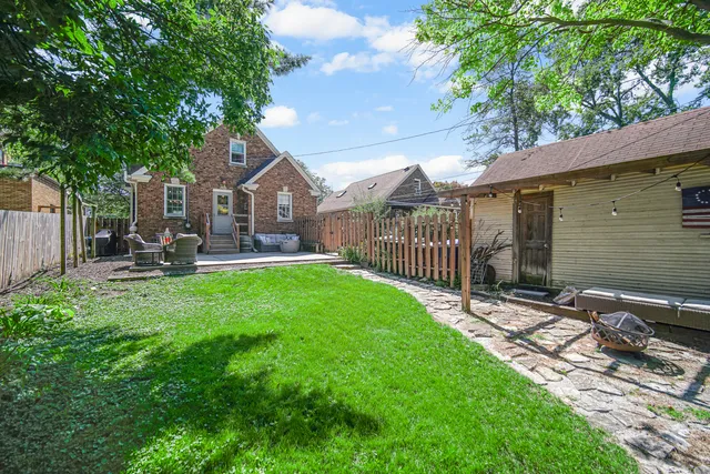 a view of a yard with a house and a tree