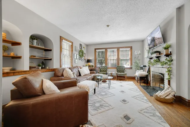 a living room with furniture and a fireplace