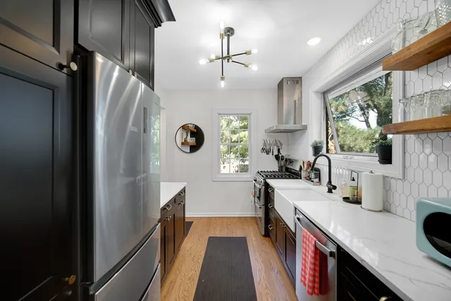 a kitchen with stainless steel appliances a sink stove and refrigerator