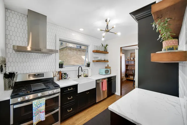 a kitchen with a stove a sink and a refrigerator