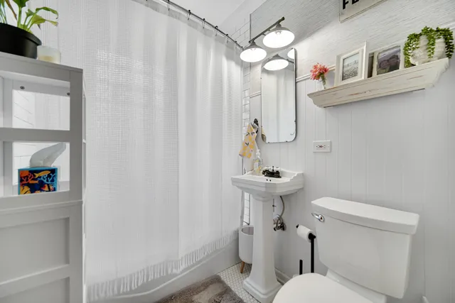 a white toilet sitting next to a bathroom sink