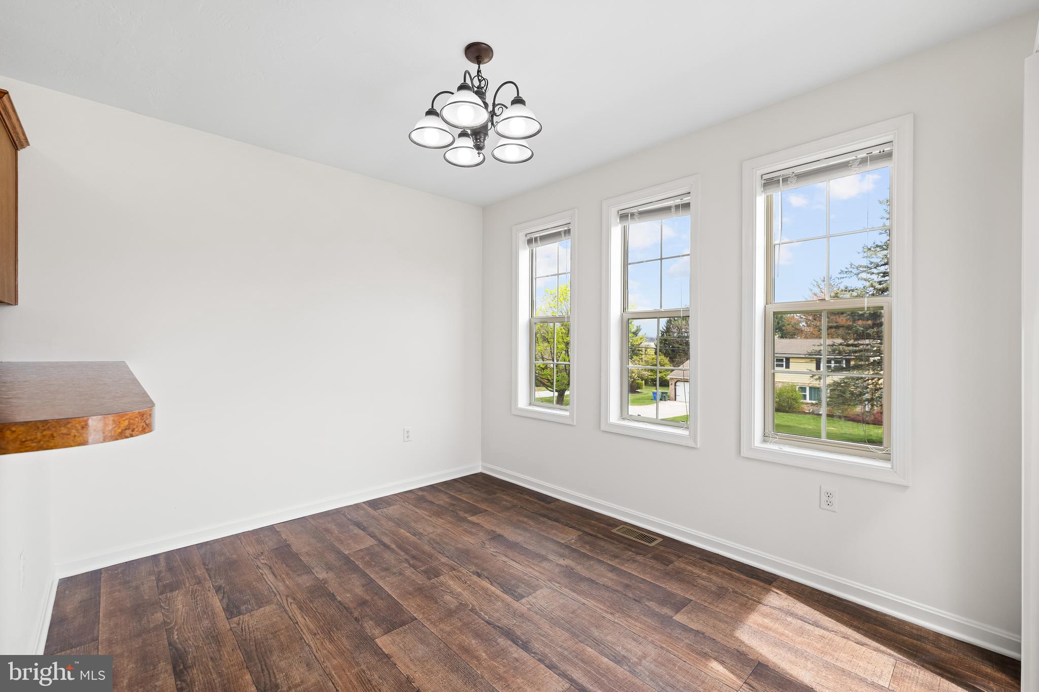 34 Shady Tree Court York, PA 17402 - Photo 8 of 22 a view of an empty room with wooden floor and a window