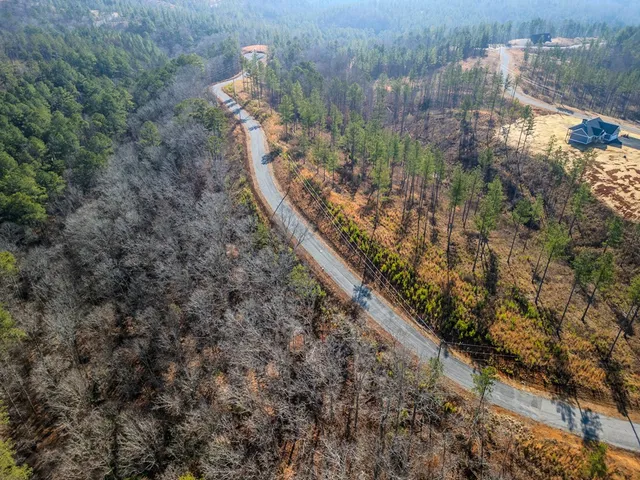 a view of a yard with wooden fence