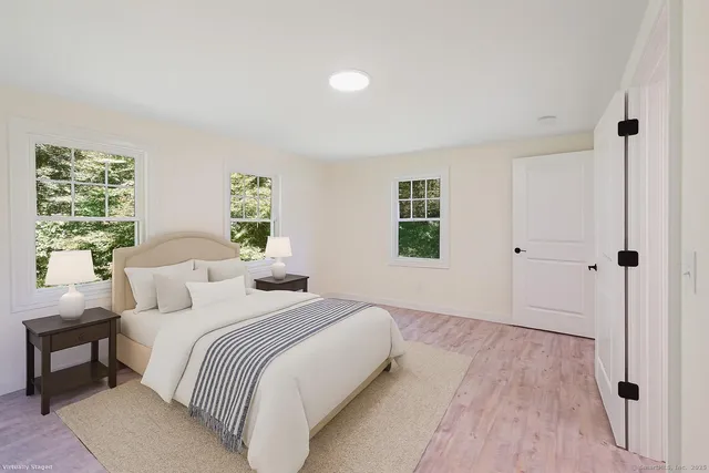 a bedroom with a bed and a window