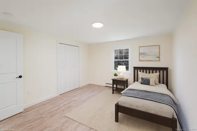 a bed room with a bed and a window