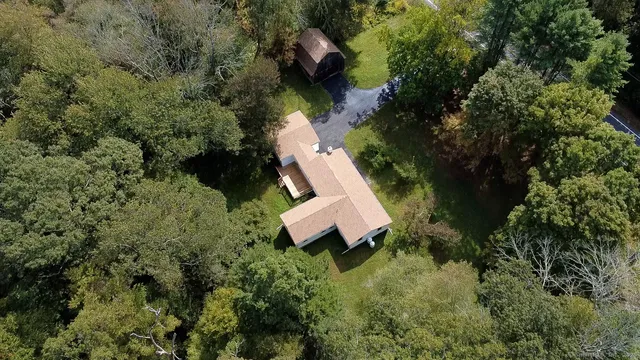 an aerial view of a house with outdoor space and street view