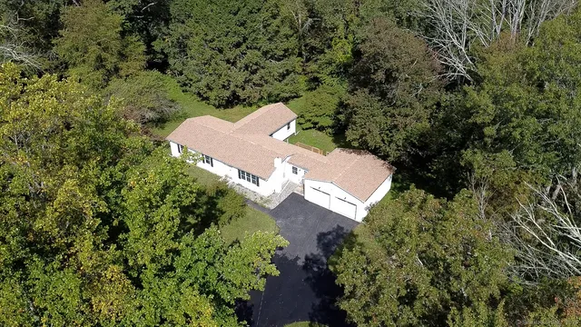 an aerial view of a house with a yard