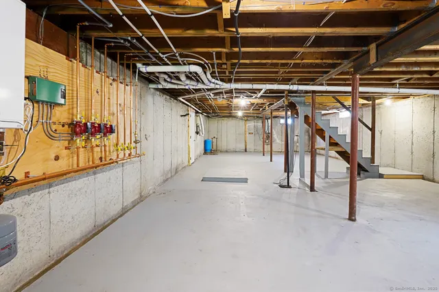 a view of an empty room with wooden stairs
