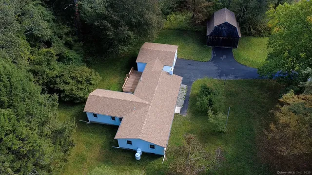 an aerial view of a house with garden space and street view