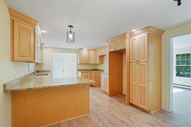 a large kitchen with a refrigerator a sink and dishwasher