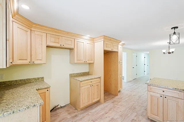 a kitchen with a refrigerator a sink and cabinets