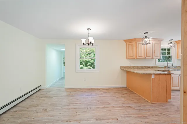 a view of kitchen with granite countertop cabinets and wooden floor