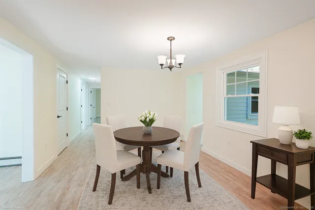 a view of a dining room with furniture and wooden floor