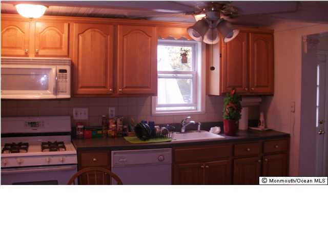 800 Wall Road Spring Lake Heights, NJ 07762 - Photo 5 of 6 a kitchen with granite countertop a sink window and cabinets