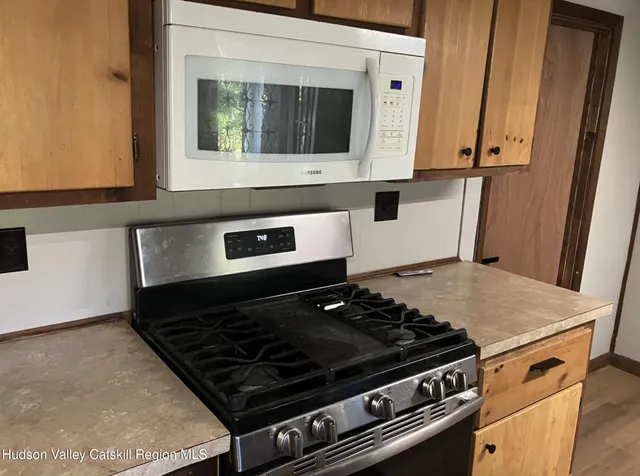a kitchen with sink a window and cabinets