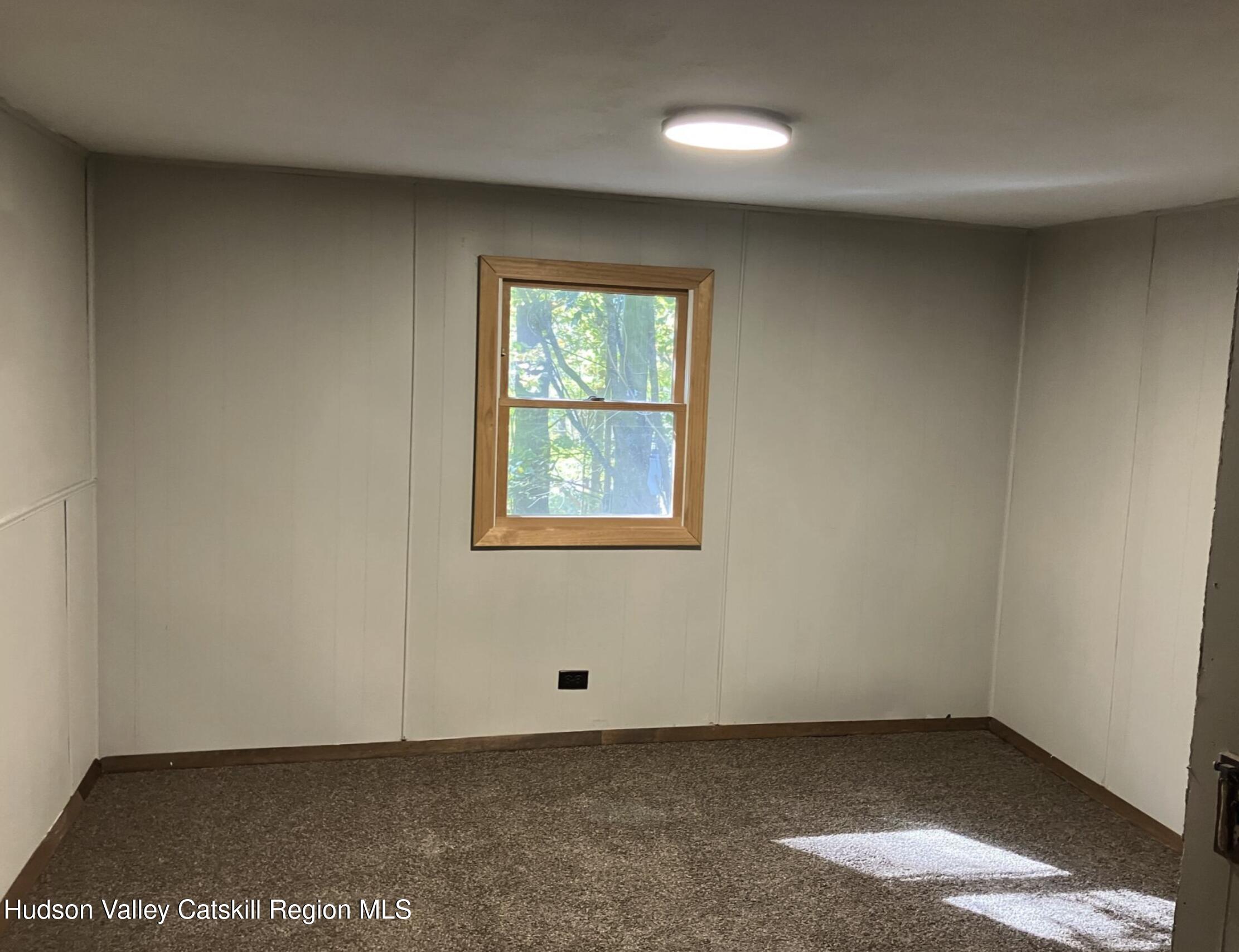 1072 Honey Hollow Road Earlton, NY 12058 - Photo 10 of 15 an empty room with a window