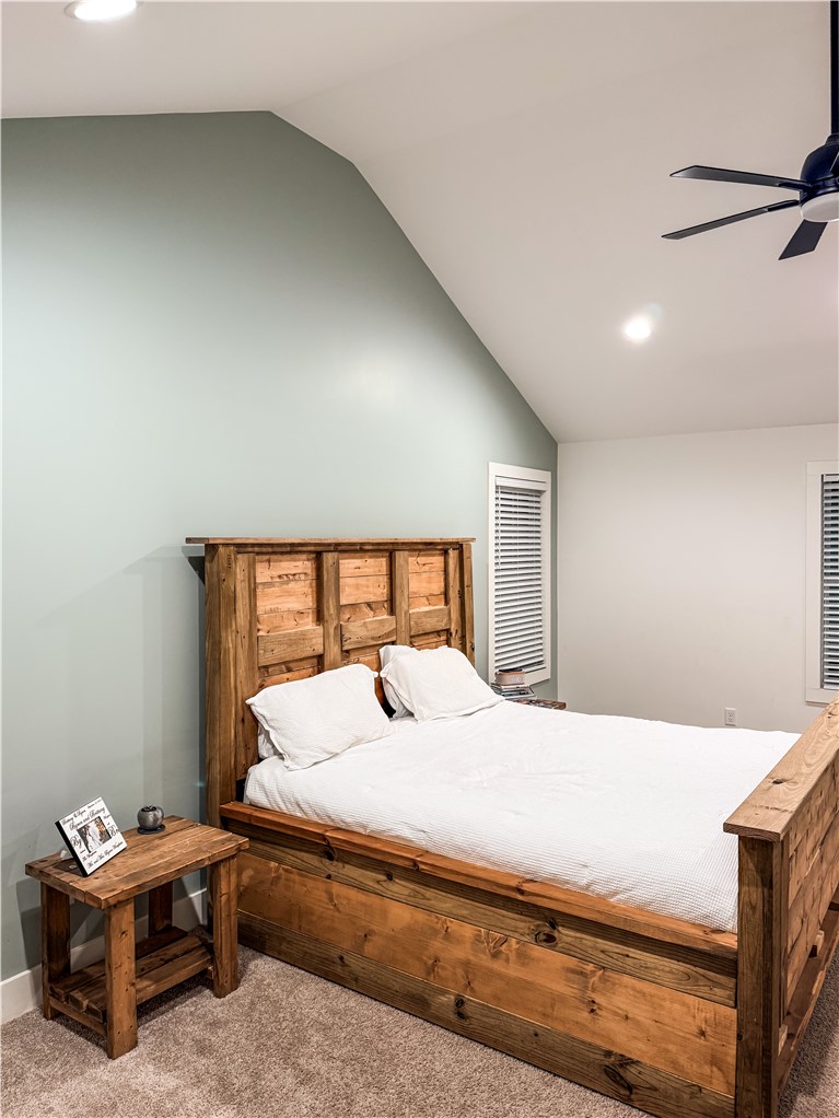757 Belle Shoals Road Pickens, SC 29671 - Photo 26 of 31 A rustic wood bed frame and side table anchor this peaceful sleeping space.
