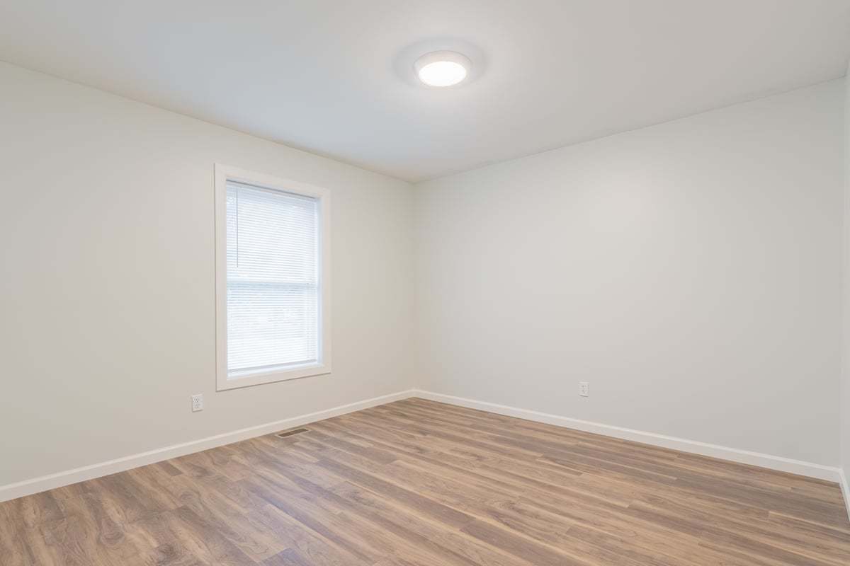 113 Prairie Run Illiopolis, IL 62539 - Photo 13 of 24 an empty room with wooden floor and windows