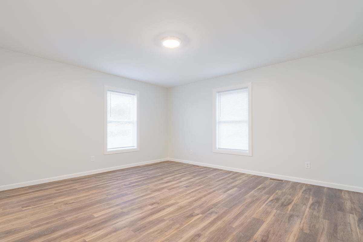 113 Prairie Run Illiopolis, IL 62539 - Photo 15 of 24 an empty room with wooden floor and windows
