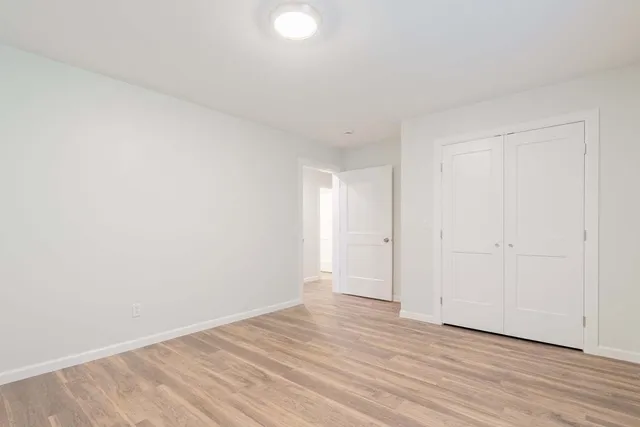 a view of an empty room and wooden floor