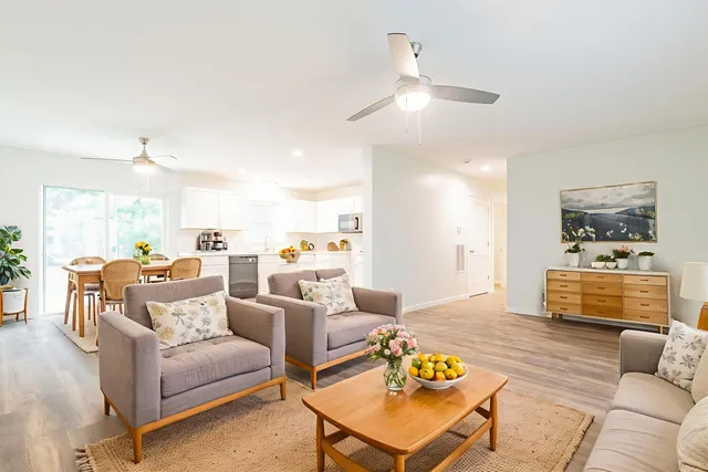 a living room with furniture fireplace and a table
