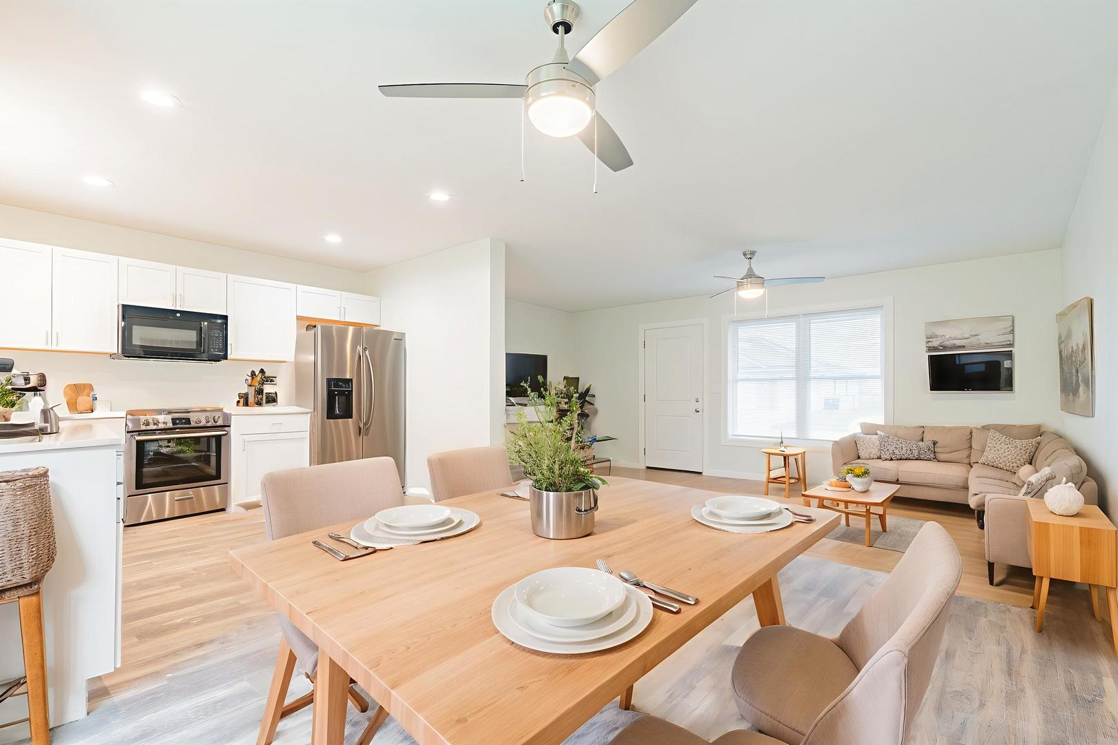113 Prairie Run Illiopolis, IL 62539 - Photo 10 of 24 a view of a dining room with furniture a kitchen and chandelier
