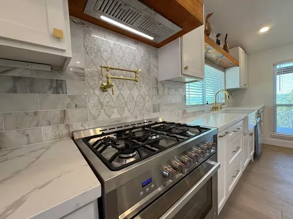 a white stove top oven sitting inside of a kitchen