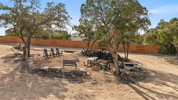 a backyard of a house with table and chairs
