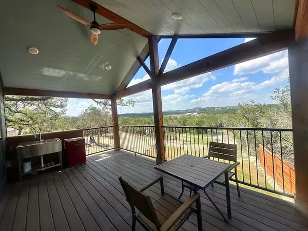 a view of a balcony with furniture and wooden floor