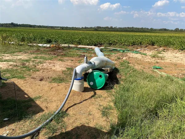 a view of a lake with a yard and sitting area