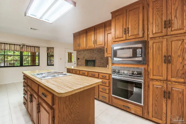 a kitchen with a stove sink and cabinets