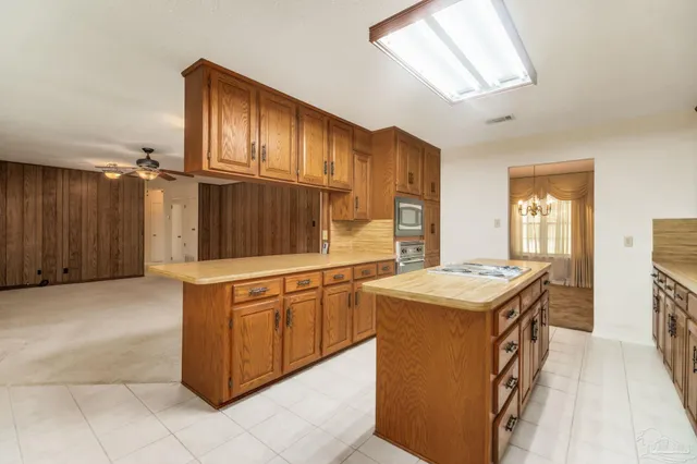 a kitchen with stainless steel appliances granite countertop a refrigerator a stove a sink and a refrigerator