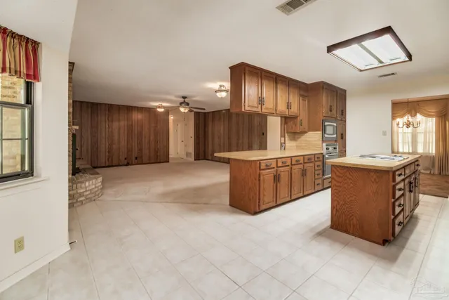 a kitchen with stainless steel appliances granite countertop a refrigerator a sink and a stove