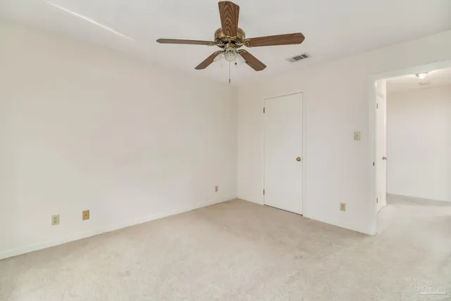 a bathroom with a granite countertop toilet and sink