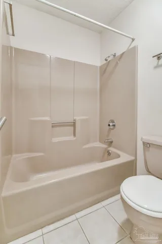 an empty room with closet and a chandelier fan