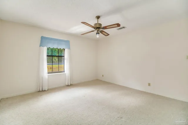 a view of a big room with a chandelier fan