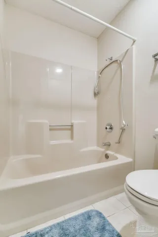 a view of an empty room with wooden floor and a floor to ceiling window