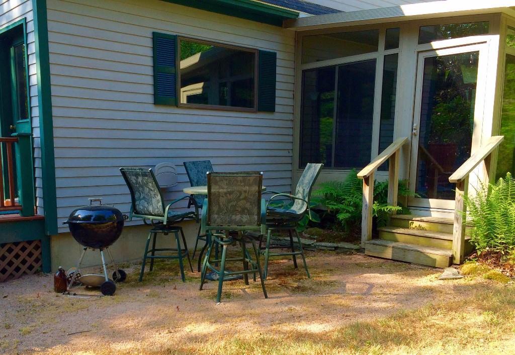884 Tremont Road Bernard, ME 04612 - Photo 6 of 24 Outdoor patio area off of the sunroom.
