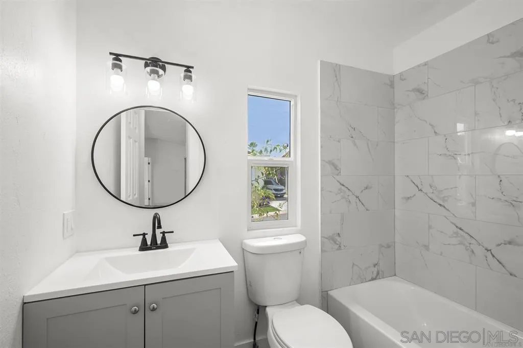 10767 Jamacha Boulevard, Unit SPC 62 Spring Valley, CA 91978 - Photo 18 of 25 a bathroom with a sink a toilet and a mirror