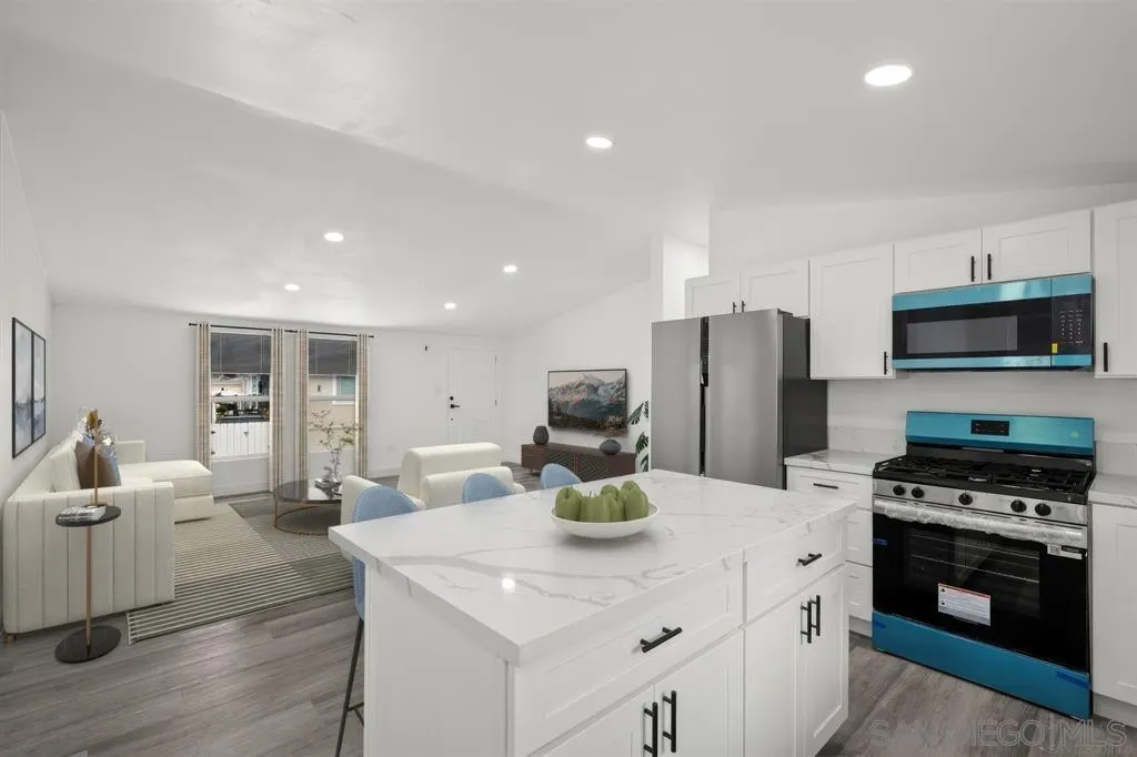 10767 Jamacha Boulevard, Unit SPC 62 Spring Valley, CA 91978 - Photo 3 of 25 a kitchen with stainless steel appliances a stove a sink a refrigerator a center island and couches