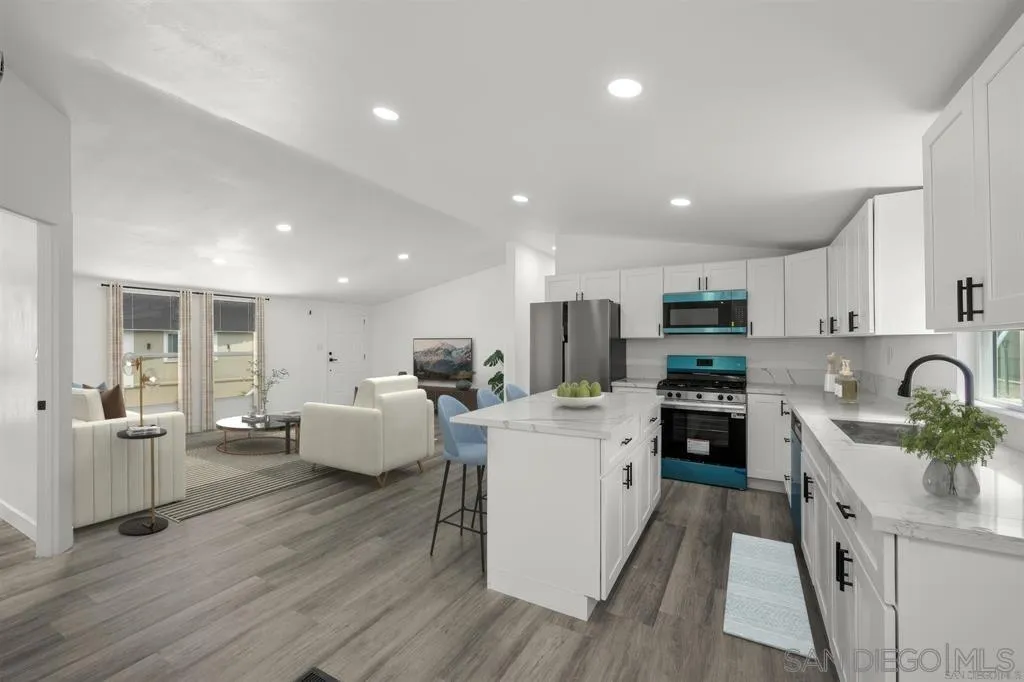 10767 Jamacha Boulevard, Unit SPC 62 Spring Valley, CA 91978 - Photo 7 of 25 a kitchen with stainless steel appliances a stove a sink a refrigerator a center island and couches